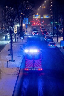 Ambulance, RTW, the Essen professional fire brigade during an emergency trip with flashing lights,