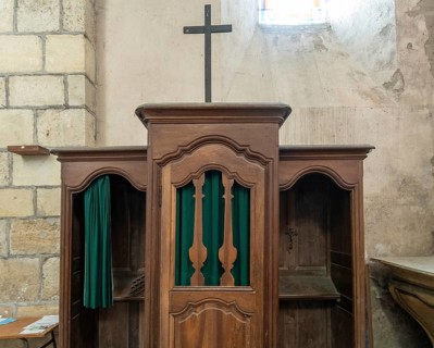 Ancient wooden confessional in a Roman Catholic church. France. Europe