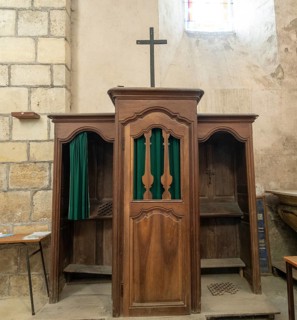 Ancient wooden confessional in a Roman Catholic church. France. Europe