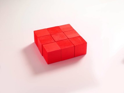 9 red wooden cubes against a white background