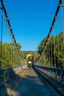 Suspension bridge of Coudes village on river Allier. Puy de Dome. Auvergne Rhone Alpes. France