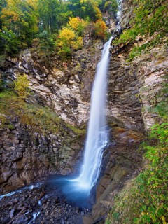 Diesbach waterfall in autumn-colored surroundings, Linthal, Klausenpass, Canton of Glarus,