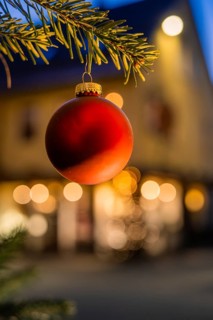 Red Christmas ball on pine branch, blurred background with lights, Nagold, Calw district, Black