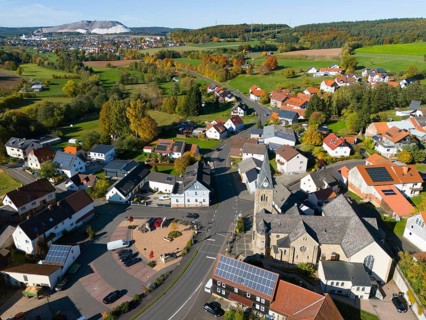 Wide view of a village with church, nestled in an autumn landscape, aerial view, Niederkalbach,