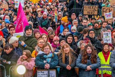 Participants with flags and posters at the demonstration against the right and for the preservation