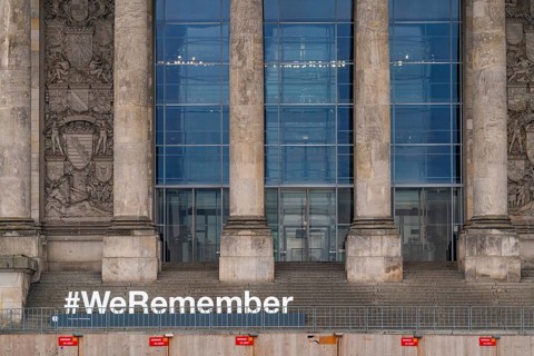 Construction fences and letters with the hashtag We Remember in memory of the victims of fascism
