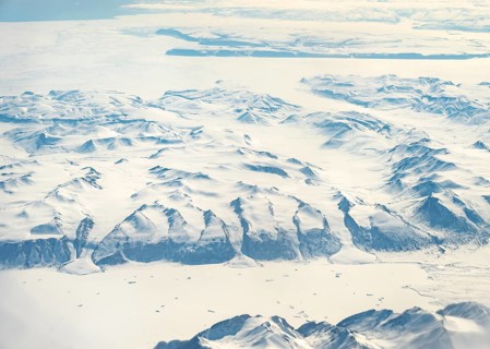 Glacier tongues flow into huge glaciers, snowy arctic mountain landscape, aerial view, Greenland,