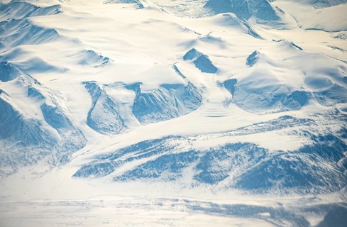 Glacier tongues flow into glaciers, snowy arctic mountain landscape, aerial view, Greenland, Arctic