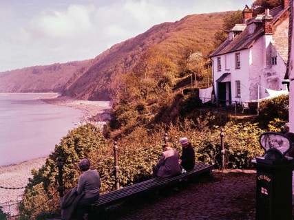View of coastline with wooden cliffs from the harbour at Clovelly, north Devon, England, UK 1960s