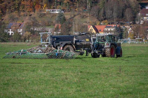 Farmer fertilizing his meadows by tow hose, Eschenbach, Middle Franconia, Bavaria, Germany