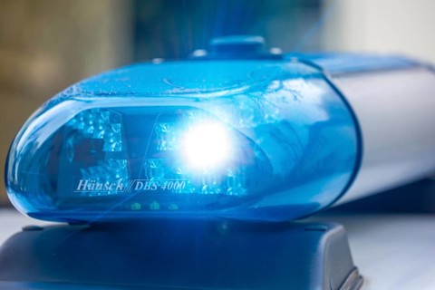 Symbolic image police operation: close-up of a blue light on a police car (digitally reworked)