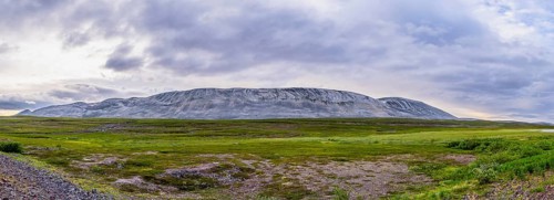 A massive granite rock mountain with bare fells dominates the landscape of the central Varanger