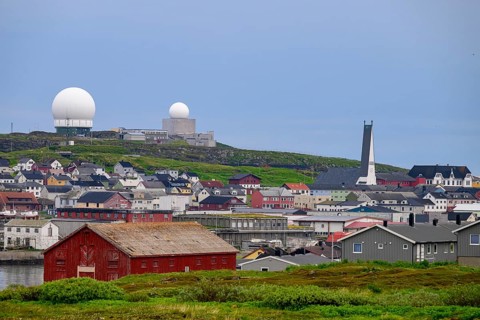 Vardø, Finnmark, Norway, city view with radar towers and a red warehouse in the foreground, under a
