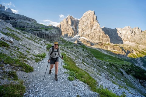 Female mountaineer in front of picturesque mountain landscape in the morning, Rifugio Ai Brentei