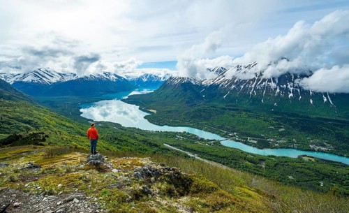 Climber enjoying the view, Slaughter Ridge Trail, view of snowy mountains and turquoise blue Kenai