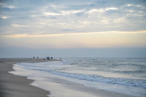 People stroll along the beach in a calm evening mood, Texel island, Noord Holland, the Netherlands