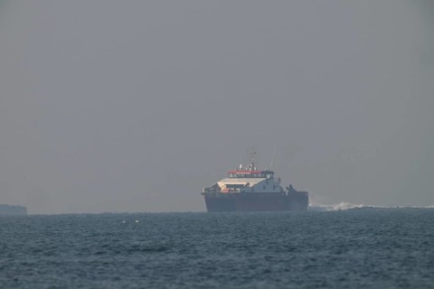 Large ship Catamaran feeder ship for offshore workers at wind farms near Heligoland sails on open