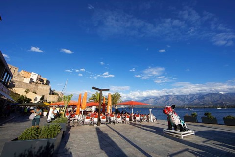 Restaurant at the marina in Calvi, with the mountains of the Balagne region in the Haute-Corse
