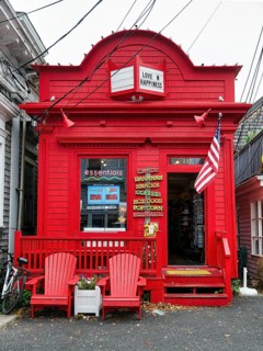 Bright red facade, fast food shop, candy, coffee, inscription love and happiness, American flag,