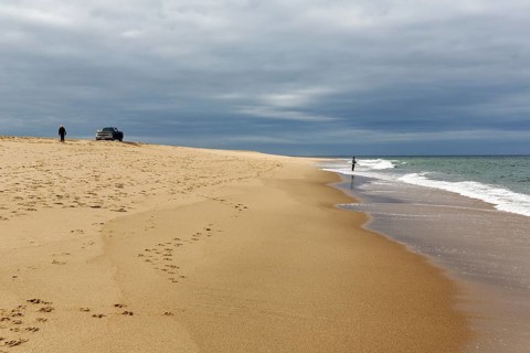 Ocean walkers, fall cloud cover, SUV on horizon, offroad, Provincetown, Race Point Beach, Cape Cod