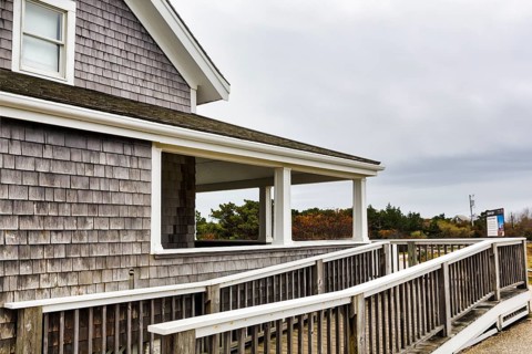 House with wooden deck, shingle façade and ramp, accessibility, typical architectural style,