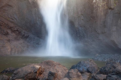 Daytime view from below of Wallaman Falls cascading into a rainforest gorge, Queensland, Australia
