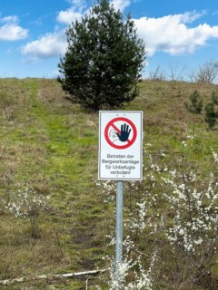 Warning sign prohibited from entering the mine complex for unauthorised persons! In front of a