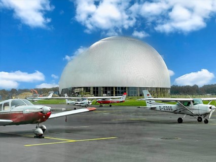 View of flight apron of Essen Mülheim airport with small aircraft parked at the front in the middle