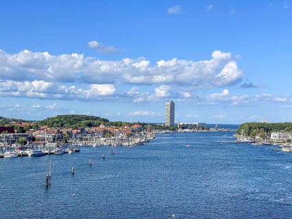 View over the Trave towards the mouth in the underground, the church of Travemünde and the Atlantic