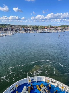 View from a ship's hull across the water towards the harbor entrance, Travemünde, Lübeck,