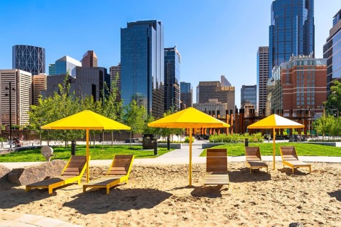 Yellow sun umbrellas and beach chairs create a vibrant pop of color against the backdrop of