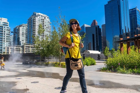 Female tourist exploring the vibrant east village neighborhood in calgary, enjoying the cityscape