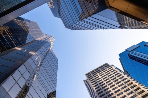 Low angle view of modern skyscrapers in calgary, canada, emphasizing their height and contemporary