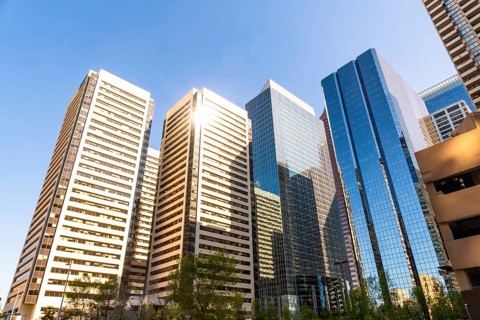 Sunlight illuminates the impressive skyscrapers of calgary's downtown core, showcasing the city's