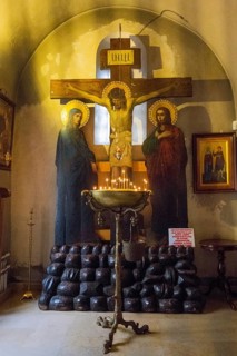 Depiction of the Crucifixion with Burning Candles in a Dark, Silent Church Room, Bodbe Monastery,