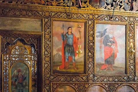 Richly decorated church icons on a wall, with golden ornaments and religious figures, Bodbe