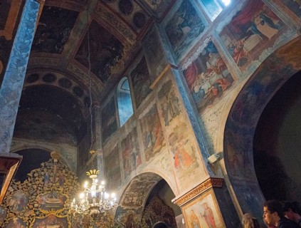 Picturesque religious scenes on walls and vaults illuminated by natural light in the church, Bodbe