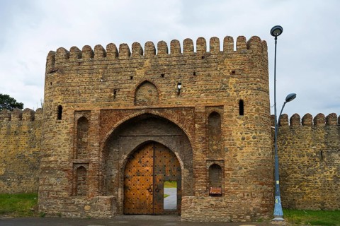 Historic fortress with high archway and massive stone walls, medieval charm, entrance gate, Batonis