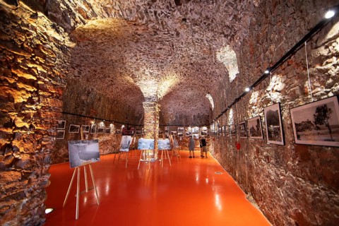 Exhibition at the Porto tourist office, a former Genoese weapons warehouse, interior view, Ota,