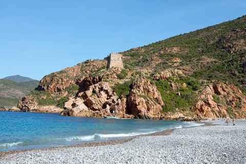 Genoese tower on the pebble beach of Porto, Ota, west coast of Corsica, Corse-du-Sud, Corsica,