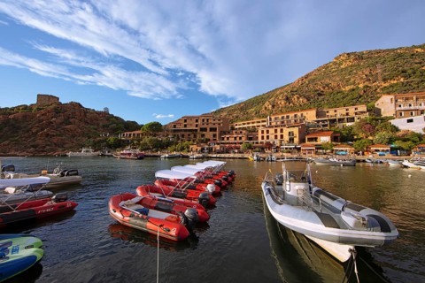 Colourful boats in Port de Porto or Port on the Porto River, behind the Genoese Tower, Porto, Ota,