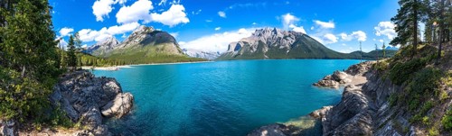 Breathtaking panoramic view of turquoise lake minnewanka surrounded by majestic rocky mountains