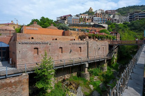River valley with a brick bridge surrounded by historic architecture, King Erekles Bath,