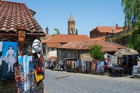 A picturesque village with souvenir stalls and old buildings that exudes a peaceful atmosphere, old