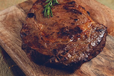 Grilled steak, beef steak, rib eye steak, on a chopping board, top view, no people