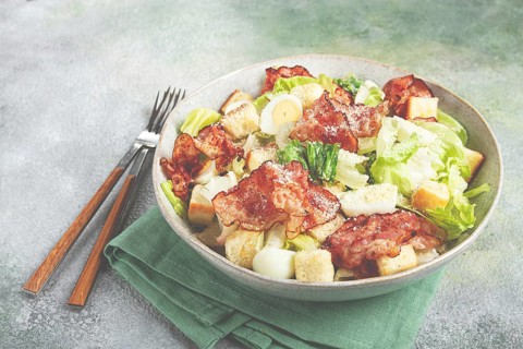 Caesar salad with fried bacon, quail eggs, homemade, no people