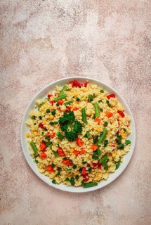 Couscous with vegetables, paprika, carrots, string beans, corn, homemade, top view, no people