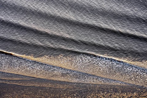 Small waves run on the beach
