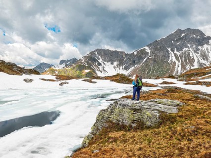 Half-frozen mountain lake with hiker, snow, Essersee, Stierkarkopf, Wildkarhöhe and Rothorn,