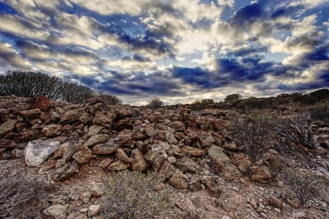 Rocky volcanic landscape under a dramatic and cloudy sky, Los Cristianos Tenerife